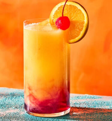 Sayuri's Solar Flare - A bright and refreshing cocktail made with tequila, triple sec, grenadine, orange juice and passionfruit juice. This drink is named for our friend, the fun and fabulous lifetime VIP, Sayuri Katsumi.