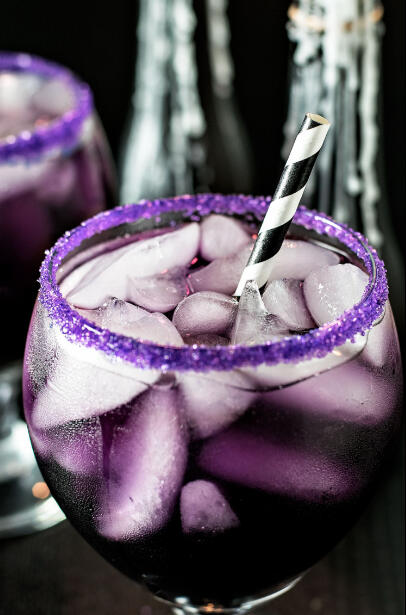 Dark Matter - This mysterious drink contains a mix of black vodka, blue curacao, grenadine, and lemonade, with purple sugar lining the rim of the glass.