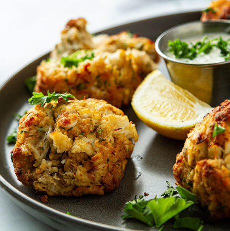 Chesapeake Crab Cakes - Freshly caught jumbo lump crab meat, rolled into our famous all-killer-no-filler cakes! Fried until crispy and golden brown on the outside and piping hot on the inside.